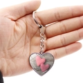 Close-up of heart-shaped keychain with fabric texture pattern held by hand on white background - Red White Plaid Striped Heart (JY008683-2)