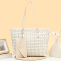Elegant tweed bucket bag with gold accents and matching mini pouch on a lifestyle setup - Off White