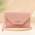 Pink leather envelope clutch bag with wristlet strap on decorative woven base - Pink