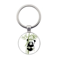 Detailed close-up of a round panda keychain with bamboo illustration and blue eyes - Blue-eyed Panda Holding Bamboo Illustration Style (JY008709-12)