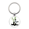 Close-up of a circular metal keychain with a cute panda holding bamboo illustration - Minimalist Sitting Panda Holding Bamboo Style (JY008709-11)