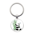 Close-up of a round metal keychain featuring a cute panda eating bamboo illustration - Panda Eating Bamboo with Dragonfly Style (JY008709-10)