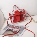 Minimalist red transparent PVC square shoulder bag with inner pouch on a white sofa - Red