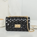 Glossy black quilted PVC jelly bag with gold chain strap and metal turn-lock closure - Black
