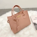 Pink lychee texture square handbag with dual handles and a matching charm accessory - Pink