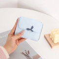 Close-up of light blue PU leather short wallet with decorative leaf buckle and embossing - Sky Blue
