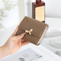 Detail view of khaki PU leather trifold wallet with leaf buckle and embroidery - Brown