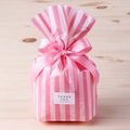 Detailed view of pink striped OPP packaging bag featuring a pink ribbon bow and sticker - Striped / 50 Pieces / Pink