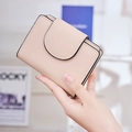 Detailed view of nude pink short wallet with cross-grain leather and black edge finish - Pink