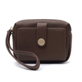 Detail of dark brown pebble leather wallet featuring a gold round buckle and wristlet strap - Brown