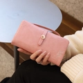 Detail of pink faux leather wallet featuring leaf embroidery and floral metal clasp - Pink