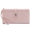 Close-up of pale pink leather wallet featuring bronze metal logo and wristlet strap detail - Pink