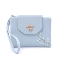 Detail of light blue PU leather wallet with gold bird buckle and floral pattern print - Blue