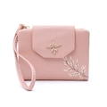 Close-up of pink PU leather wallet featuring golden bird buckle and leaf print detail - Orange