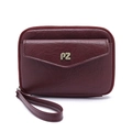 Macro shot of maroon leather passport bag with gold PZ logo and secure zipper closure - Burgundy