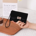 Elegant black matte leather women's wallet with gold buckle and wrist strap - Black