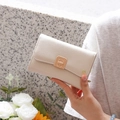 Detailed side view of cream faux leather wallet with gold buckle and pleated texture - Off-white