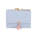 Detail of light blue tri-fold wallet featuring gold heart clasp and leaf pendant accessory - Blue