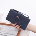 Close-up of deep blue suede long wallet with gold metal ring detail and wrist strap - Sapphire Blue