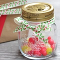 Christmas printed ribbon tied on a clear glass storage jar with golden lid and candies - Christmas Green Leaves / 1cm*23m