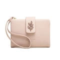 Detail of light pink leather wallet featuring a decorative leaf clasp and wrist strap - Pink