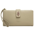 Detail of olive green wallet featuring leaf embossed snap buckle and detachable wristlet - Grey Green