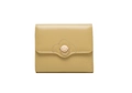 Detail of a mustard yellow tri-fold wallet with flower metal buckle and leather texture - Ginger Yellow