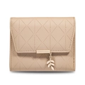 Detail view of beige quilted wallet with brand metal plaque and gold leaf pendant - Camel