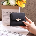Close-up of black PU leather wallet featuring a stylish gold leaf clasp decoration - Black