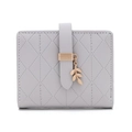 Detail of grey quilted leather wallet with rose gold leaf charm and buckle closure - Gray