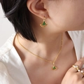 Set di gioielli dorati con ciondoli a foglia di ginkgo verde indossati da una modella - Orecchini a Forma di Ventaglio con Foglia di Ginkgo / Oro