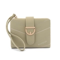 Detail of light green quilted leather wallet with gold buckle and wristlet strap - Green