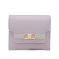 Detailed close-up of light purple synthetic leather wallet with gold buckle clasp - Purple