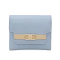 Close-up of light blue trifold wallet featuring golden buckle and Prettysys brand logo - Blue