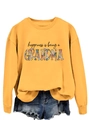 Close-up of yellow sweatshirt with floral Grandma print and casual knitted texture - Yellow Sweatshirt (Black Text Pattern)