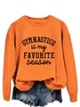 Detailopname van oranje sweatshirt met Gymnastics is my Favorite Season tekstbedrukking - S / Oranje Sweatshirt (Zwart Lettertype)