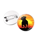 Detail of metal badge showing sunset horse silhouette and secure safety pin fastener - Silver
