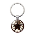 Western Texas cowboy keychain featuring silver star on cow print glass pendant - Silver Cow Print Star