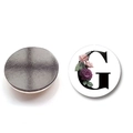 Macro detail of round crystal glass fridge magnet featuring letter G and floral patterns - Letter G Style (XSWX6582-G)