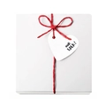 White gift box with red ribbon bow and heart-shaped OOH LALA tag on white background - White