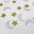 Macro shot of gold star and silver moon glitter confetti for party table decorations - Silver Moon Gold Star Style