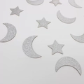 Macro shot of silver glitter moon and star confetti for festive party table decorations - Silver Star Moon Style