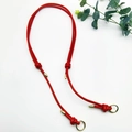 Detail of red leather shoulder strap with golden metal clasps and handcrafted knots - Gold Ring Buckle / Red