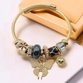 Golden charm bracelet with pearl butterfly, black heart, and sparkling crystal pendants - KC Gold Black