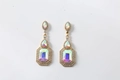 Close-up of vintage gold earrings with AB iridescent crystals and micro-paved rhinestones - AB White
