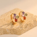 Gold-plated hoop earrings with colorful gemstone clusters on a beige stone surface - Multicolor Zircon Inlay Style (H-11483)