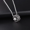 Macro shot of silver ring pendant with engraved Gothic cross pattern and box chain - A-46