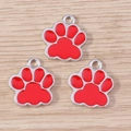 Close-up of red enamel cat paw charms with silver alloy plating for DIY jewelry making - 10 Pieces Pack / Red