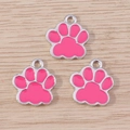 Three pink cat paw alloy charms with silver trim for DIY jewelry making on wood background - 10 Pieces Pack / Rose Red