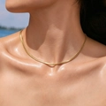 PVD gold plated stainless steel snake chain necklace worn by a model on a sunny beach - Gold Single Flat Snake Chain